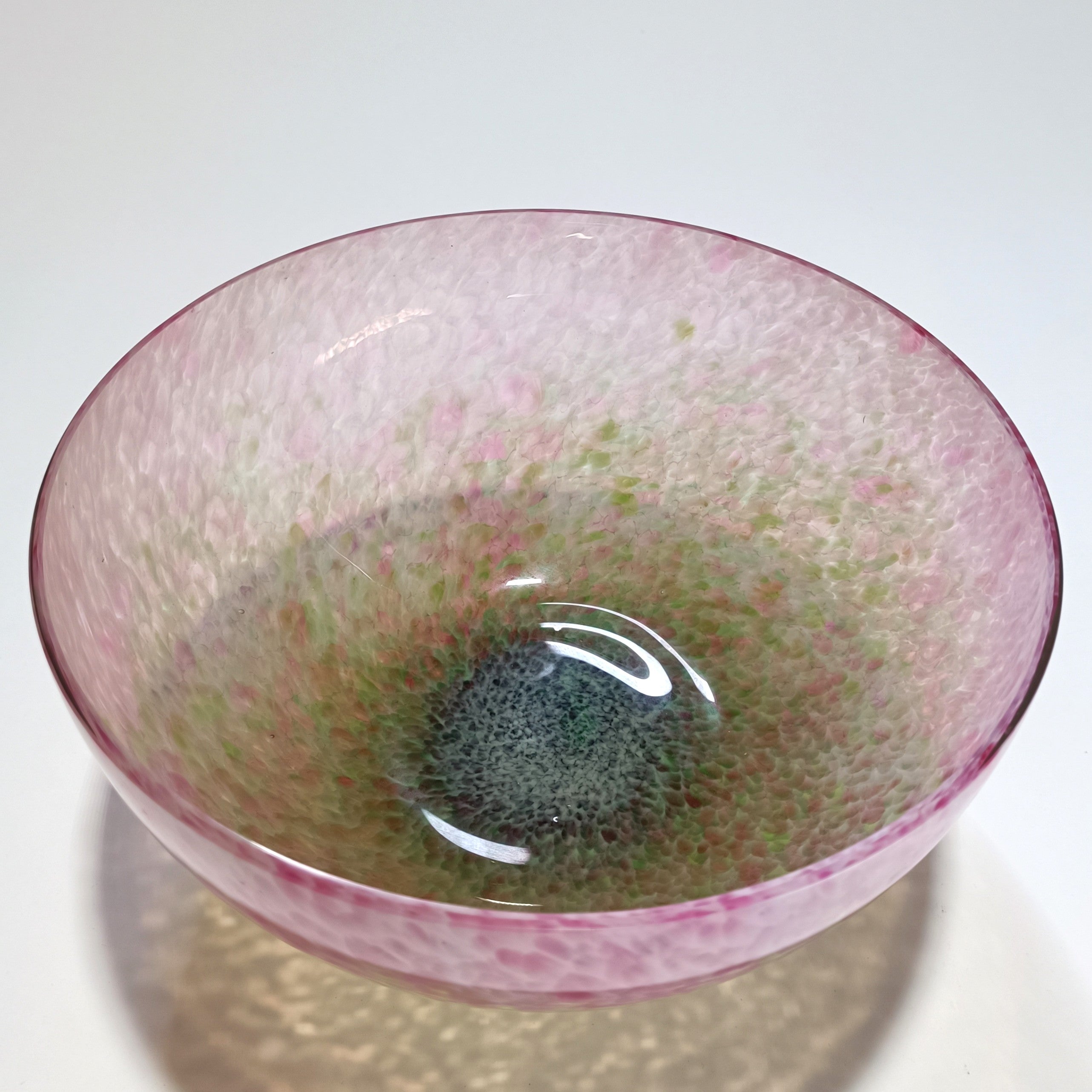 Handblown glass bowl with pink speckled texture and soft green base