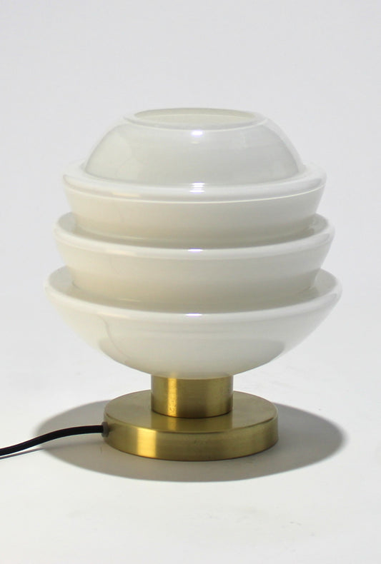 Lámpara de mesa de cristal opalino con base metálica.