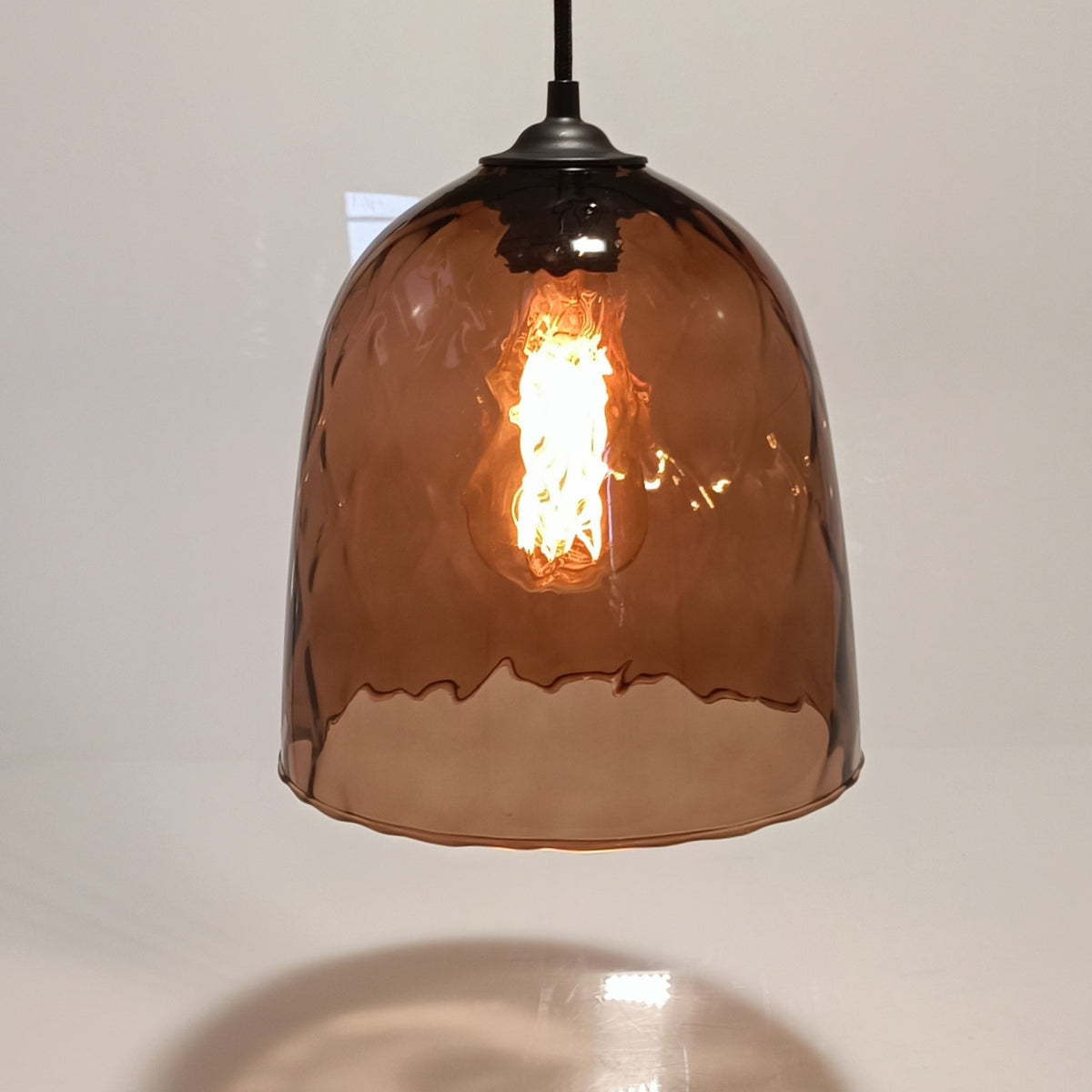 Ceiling pendant light DÔMEA in wine-brown blown glass, lit, dome-shaped shade with black cord